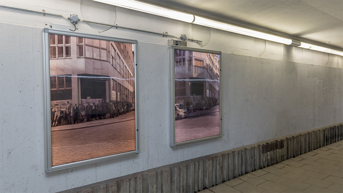 Large framed photographs in a subway.