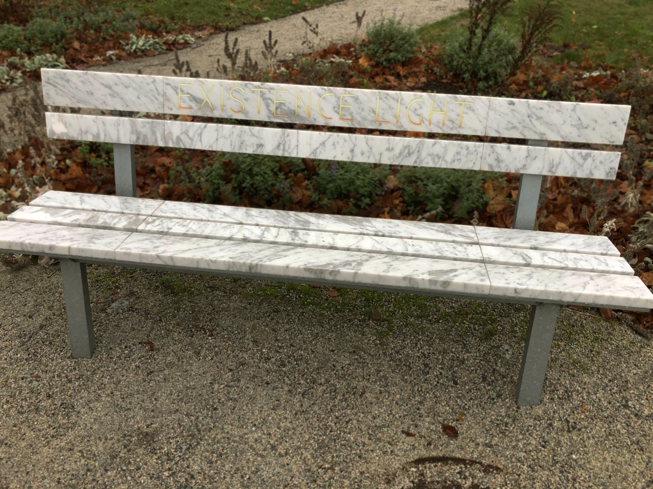 A park bench where the slats consist of marble instead of ordinary wood.